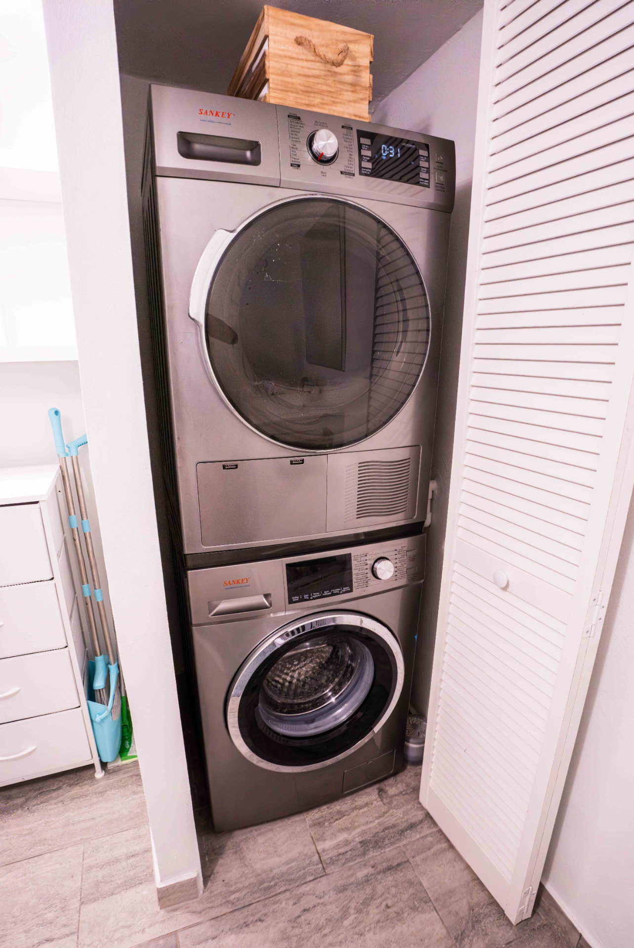 In unit washer and dryer tucked behind louvered doors