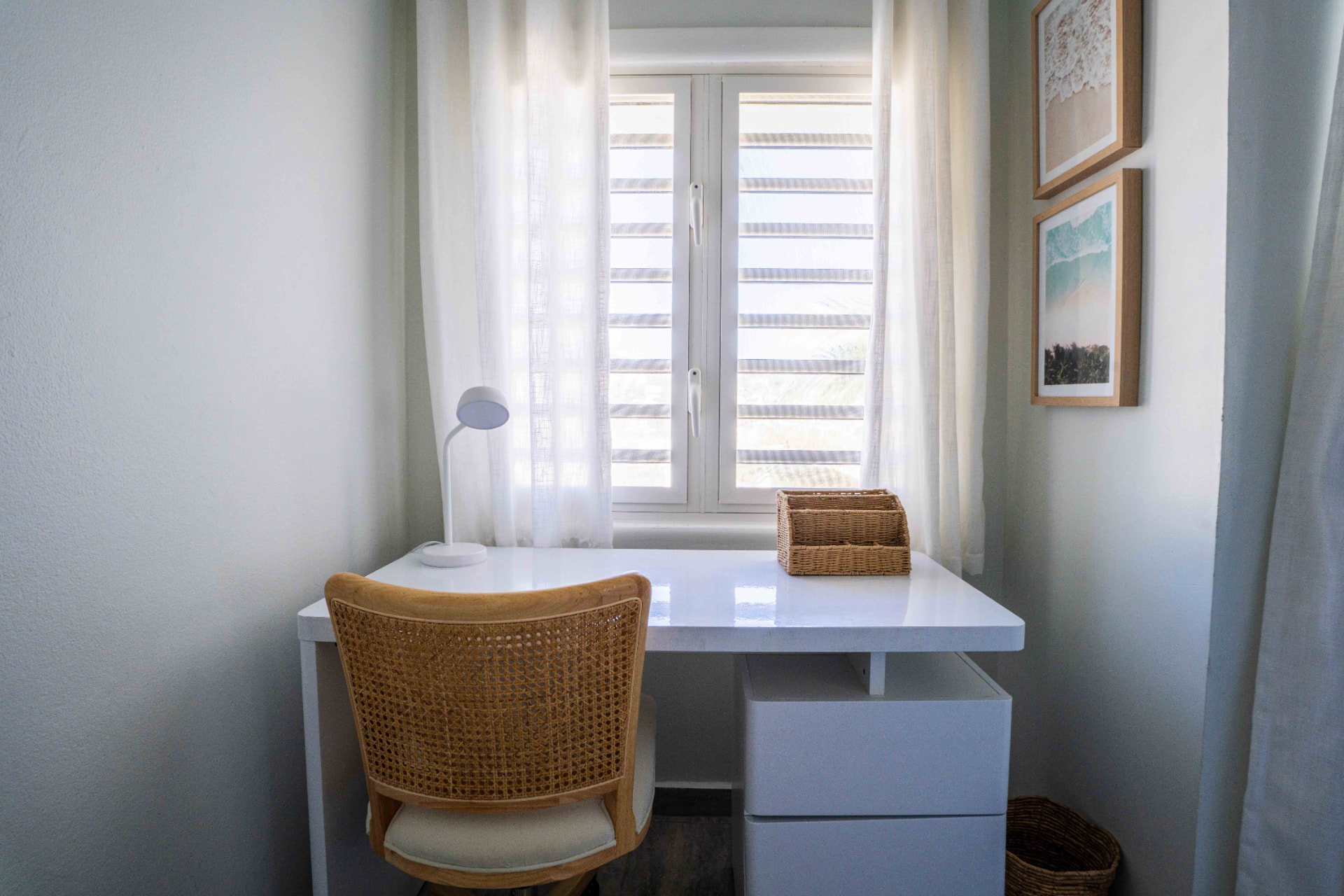 Quiet workspace with desk, cane chair and window light