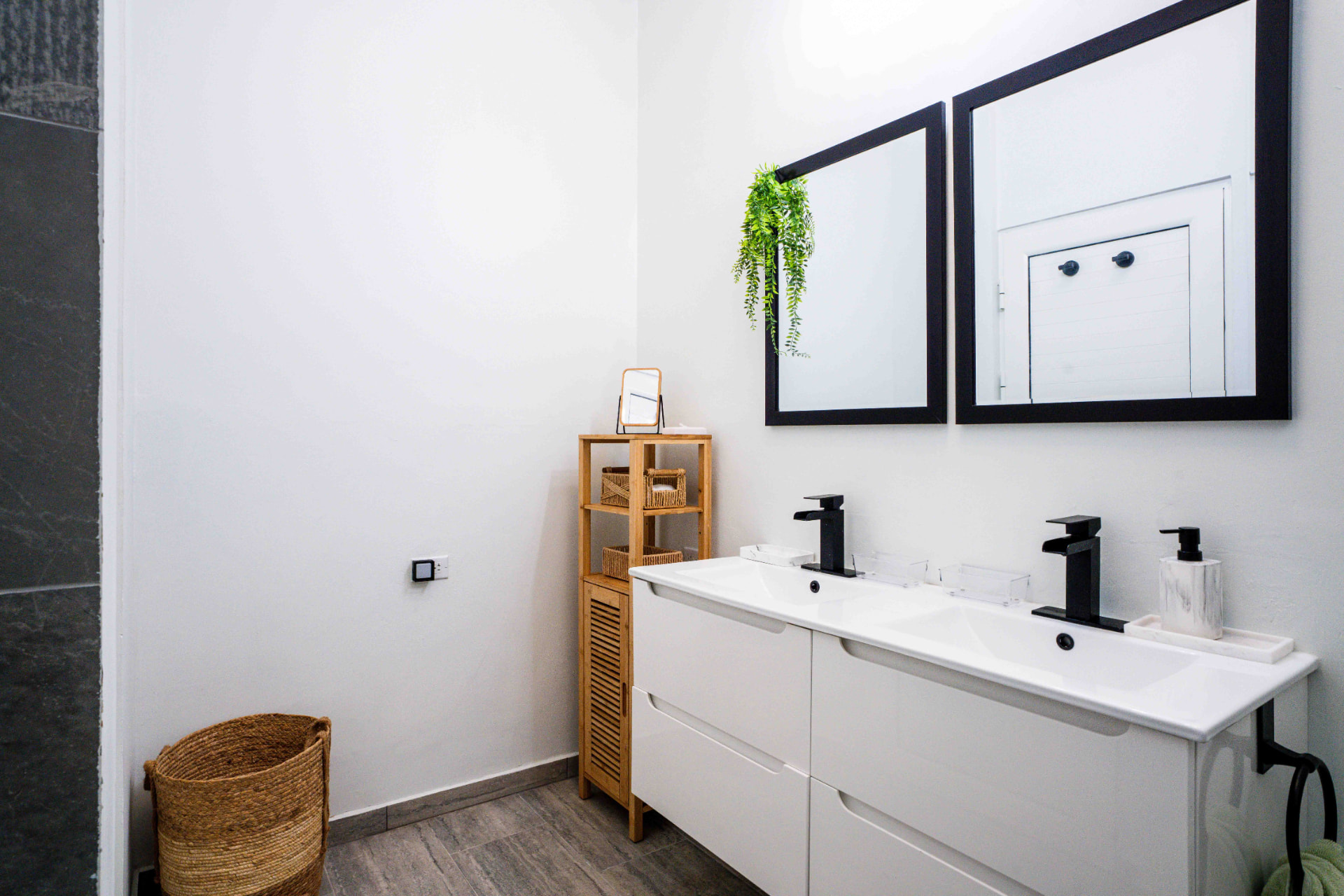 Double vanity with twin mirrors and black fixtures
