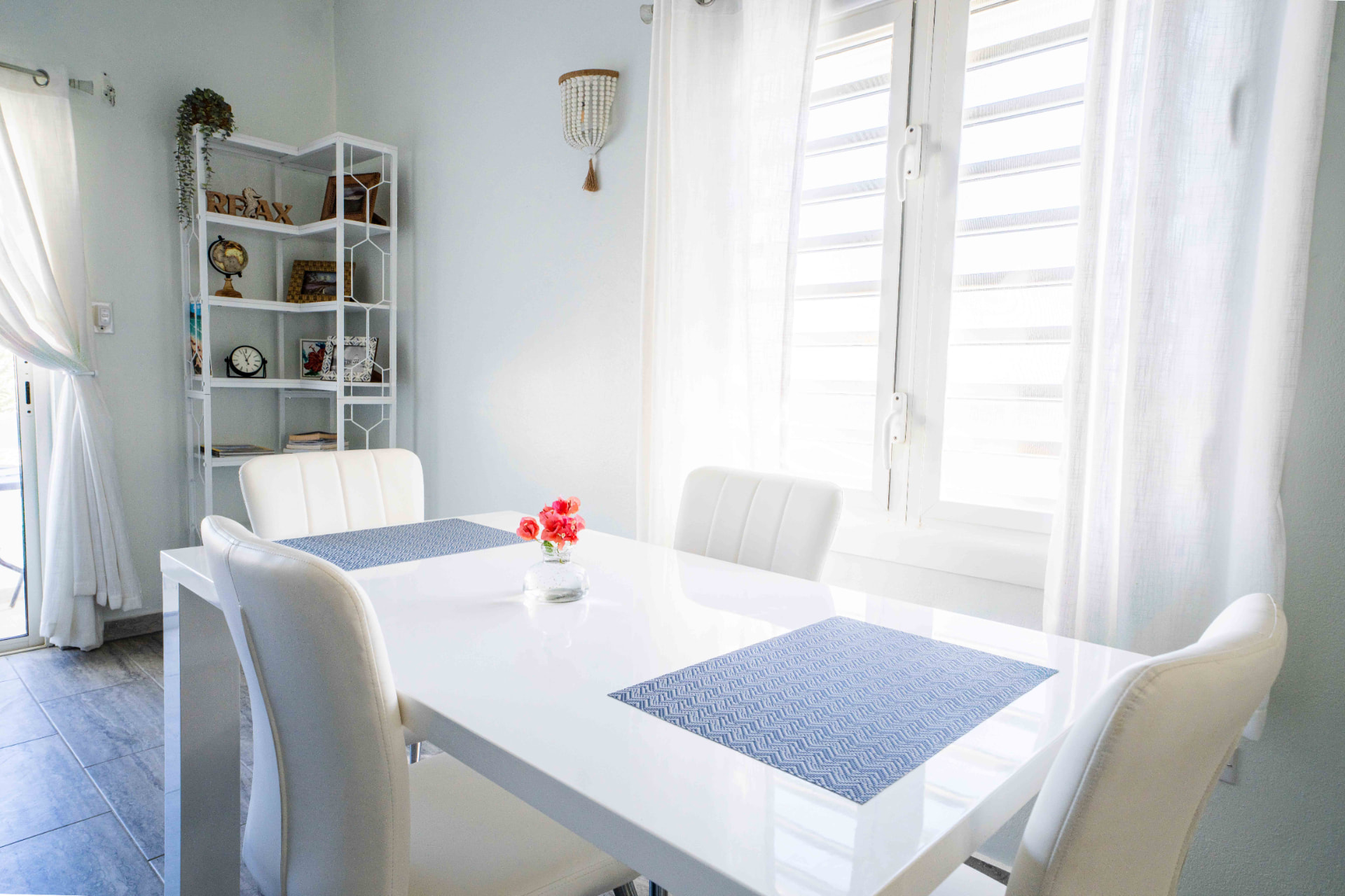 Dining table set for four with fresh flowers