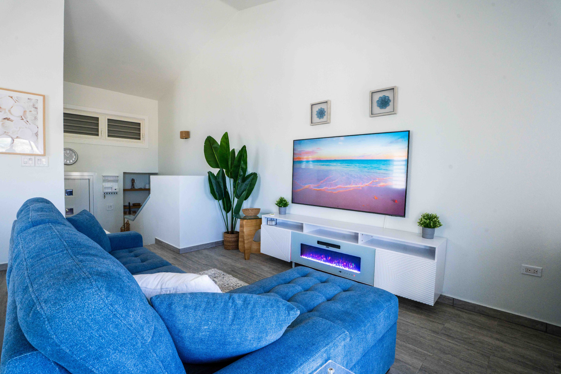 Living room with blue sectional sofa and smart TV