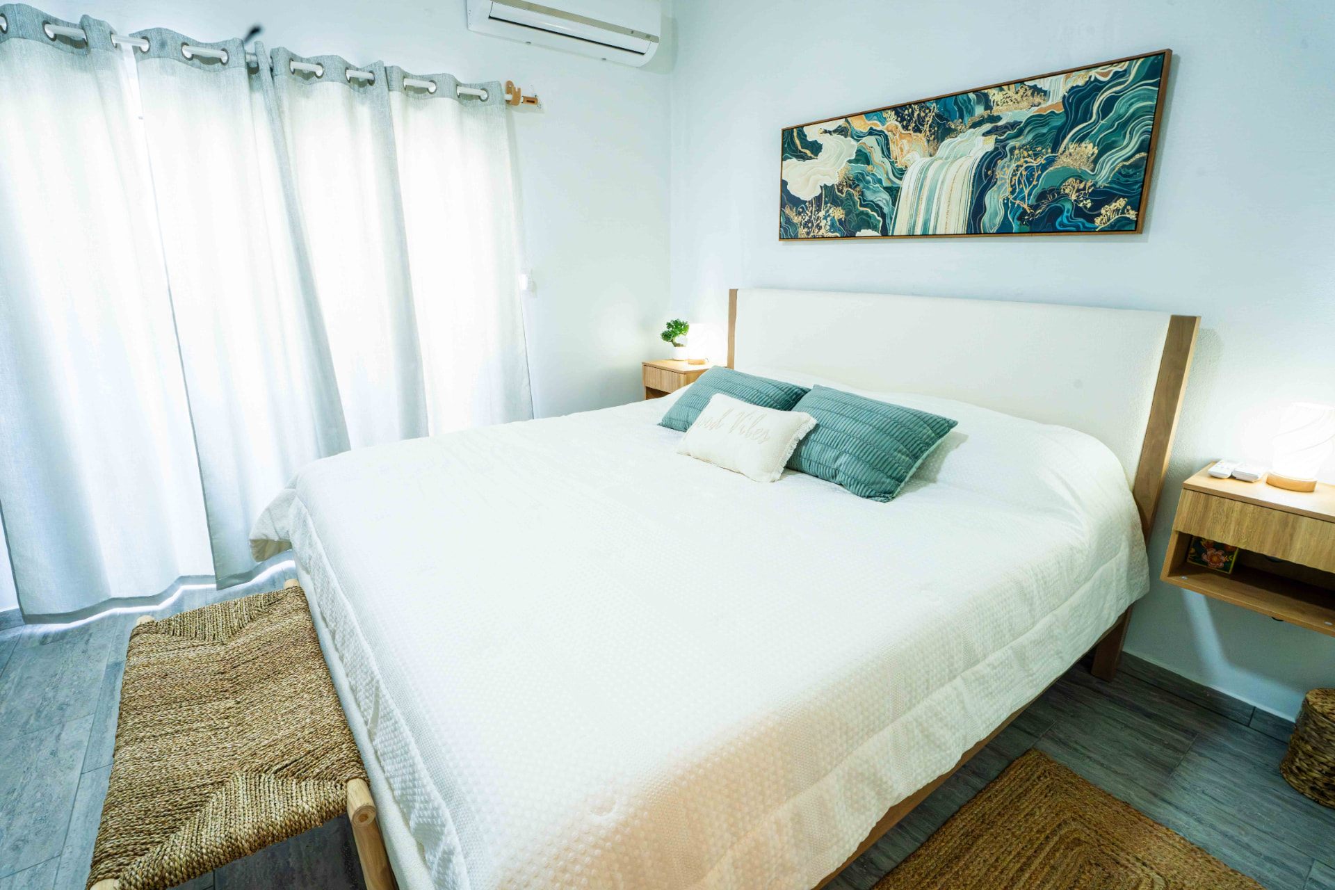 King bed with soft linens and bright window light