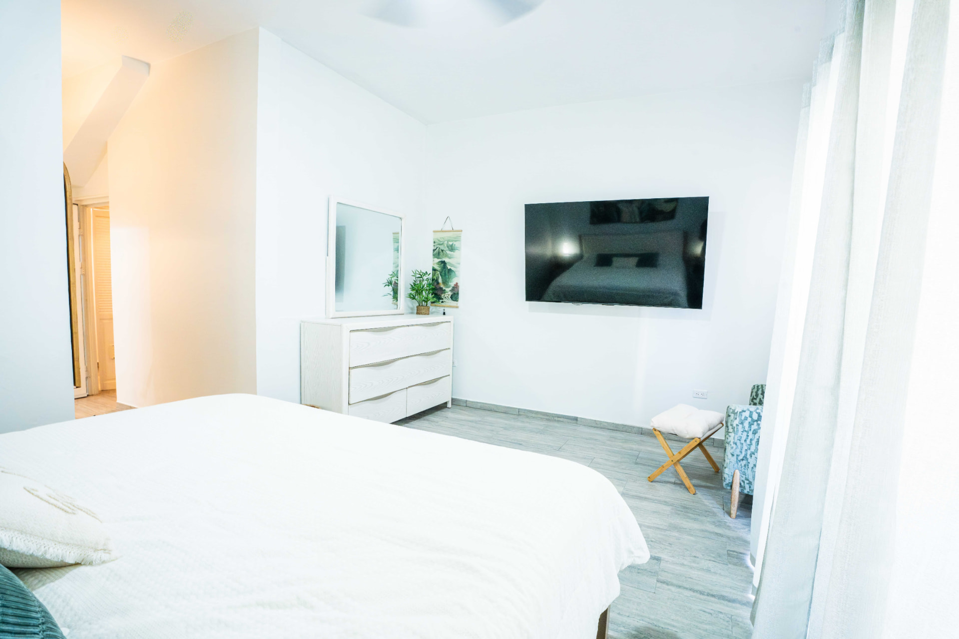 Bedroom with dresser, mirror and view to the bathroom