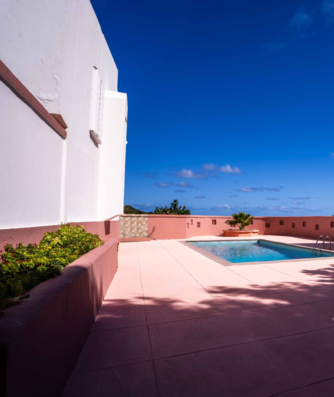 Sunlit pool deck looking out towards the horizon