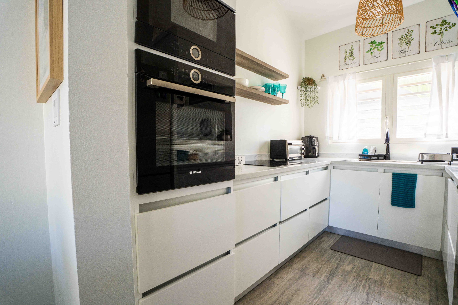 Kitchen with Bosch oven, induction cooktop and open shelving